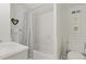 Bright bathroom with a shower-tub combo, white wainscoting, and soft decor at 2060 Wappoo Hall Rd, Charleston, SC 29412