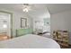 Bedroom featuring a crib, green dresser, and white wainscoting throughout at 2060 Wappoo Hall Rd, Charleston, SC 29412