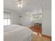 Bright bedroom featuring wainscoting walls, hardwood floors, and multiple windows at 2060 Wappoo Hall Rd, Charleston, SC 29412