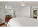 Bedroom with wainscoting, light hardwood floors, ceiling fan, and a ladder for decoration at 2060 Wappoo Hall Rd, Charleston, SC 29412