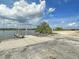 Concrete boat ramp with wooden docks offering convenient access to the waterway under a cloudy sky at 2060 Wappoo Hall Rd, Charleston, SC 29412
