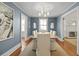 Dining room with blue walls, wood table with white chairs, and natural light from the window at 2060 Wappoo Hall Rd, Charleston, SC 29412
