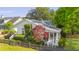 Charming home with a screened porch, vibrant foliage, and a classic picket fence at 2060 Wappoo Hall Rd, Charleston, SC 29412