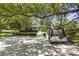 Charming home with a manicured front yard, mature trees, and a golf cart parked in the driveway at 2060 Wappoo Hall Rd, Charleston, SC 29412