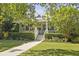 Inviting two-story home with a covered porch, manicured hedges, and a charming walkway leading to the front door at 2060 Wappoo Hall Rd, Charleston, SC 29412