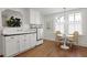 Bright kitchen featuring white cabinetry, breakfast table with seating, and stainless appliances at 2060 Wappoo Hall Rd, Charleston, SC 29412