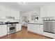 Bright kitchen showcasing stainless steel appliances, white cabinets, and an open floor plan at 2060 Wappoo Hall Rd, Charleston, SC 29412