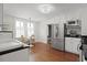 Eat-in kitchen boasts stainless steel appliances, white cabinets, and a breakfast nook at 2060 Wappoo Hall Rd, Charleston, SC 29412