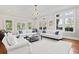 Beautiful living room with large windows offering natural light and hardwood floors at 2060 Wappoo Hall Rd, Charleston, SC 29412