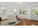 Bright living room featuring hardwood floors, a fireplace, and a comfortable armchair near a sunny window at 2060 Wappoo Hall Rd, Charleston, SC 29412