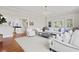 Bright living room with hardwood floors, a decorative chandelier, and white furnishings at 2060 Wappoo Hall Rd, Charleston, SC 29412