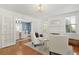 Bright living room featuring hardwood floors, neutral furniture, and an open doorway to the dining room at 2060 Wappoo Hall Rd, Charleston, SC 29412