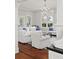 Bright and airy living room with white furniture and views from the windows at 2060 Wappoo Hall Rd, Charleston, SC 29412