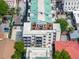 Aerial view of a modern apartment building with a rooftop terrace and outdoor seating areas at 21 George St # 206, Charleston, SC 29401