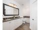 Bathroom featuring double sinks, granite countertops, and separate tub and toilet area at 21 George St # 206, Charleston, SC 29401