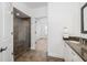 Bathroom featuring granite countertops, tiled floors, and a glass-enclosed shower at 21 George St # 206, Charleston, SC 29401