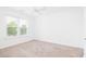 Bright, carpeted bedroom featuring a ceiling fan and natural light from a window at 21 George St # 206, Charleston, SC 29401