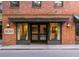 Building entrance with number 21, flanked by brick and black trim at 21 George St # 206, Charleston, SC 29401