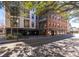 Modern building featuring brick and grey facade with balconies and street views at 21 George St # 206, Charleston, SC 29401