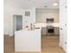 Modern kitchen features stainless steel appliances, a sleek white countertop island, and hardwood floors at 21 George St # 206, Charleston, SC 29401