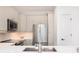 Close up on the sleek modern kitchen with stainless steel appliances, stylish cabinetry, and a clean design at 21 George St # 206, Charleston, SC 29401