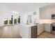 Bright kitchen features a large island, stainless appliances, and an open layout perfect for modern living at 21 George St # 206, Charleston, SC 29401