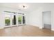 Spacious living room with hardwood floors, bright natural light, and balcony access showcasing the city at 21 George St # 206, Charleston, SC 29401