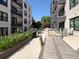 A community patio area featuring tables, chairs, grill, and lush planters at 21 George St # 206, Charleston, SC 29401