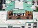 An inviting rooftop terrace offers a stylish lounge and dining furniture set with light green roof at 21 George St # 206, Charleston, SC 29401