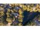 Aerial view of a home nestled among trees, featuring a pond and spacious surroundings at 2105 Loblolly Ln, Seabrook Island, SC 29455