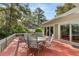 Outdoor deck with dining table and seating, offering picturesque views of the surrounding scenery at 2105 Loblolly Ln, Seabrook Island, SC 29455