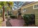 Back patio with red steps, landscaping, and a path leading to the backyard and greenery at 2105 Loblolly Ln, Seabrook Island, SC 29455