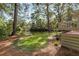 Expansive backyard featuring a tranquil lake, mature trees, lush greenery, and access to a deck at 2105 Loblolly Ln, Seabrook Island, SC 29455