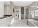 A spacious bathroom with walk-in shower, soaker tub, and white vanities is bright and inviting at 2105 Loblolly Ln, Seabrook Island, SC 29455