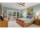 Serene bedroom with a ceiling fan, a deck view, neutral colors, and comfortable furnishings at 2105 Loblolly Ln, Seabrook Island, SC 29455