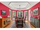Elegant dining room with large windows, a tray ceiling, and hardwood floors at 2105 Loblolly Ln, Seabrook Island, SC 29455