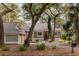 Inviting one-story home with a driveway, green lawn, beautiful landscaping, and a cozy curb appeal at 2105 Loblolly Ln, Seabrook Island, SC 29455