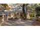 Charming home with a well-manicured lawn, mature trees, and a welcoming front entrance at 2105 Loblolly Ln, Seabrook Island, SC 29455