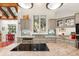 Bright kitchen featuring stone countertops, stainless appliances, and ample cabinet space at 2105 Loblolly Ln, Seabrook Island, SC 29455