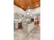 Well-lit kitchen with stone countertops, stainless steel appliances, and wooden ceiling at 2105 Loblolly Ln, Seabrook Island, SC 29455