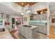 Spacious kitchen with an island, granite countertops, pendant lighting, and adjacent dining area at 2105 Loblolly Ln, Seabrook Island, SC 29455