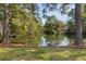 Scenic lake view surrounded by tall pine trees and beautiful reflections on the water at 2105 Loblolly Ln, Seabrook Island, SC 29455