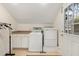 Well-lit laundry room with a washer, dryer, counter space, and access to the outside at 2105 Loblolly Ln, Seabrook Island, SC 29455