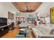 Spacious living room with hardwood floors, white couches, and a ceiling fan at 2105 Loblolly Ln, Seabrook Island, SC 29455