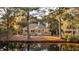 Beautiful home surrounded by nature, complemented by a serene pond and lush greenery at 2105 Loblolly Ln, Seabrook Island, SC 29455