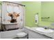 Unique bathroom with cow print shower curtain and green walls, plus a white vanity at 222 Sinclair Rd, Summerville, SC 29483