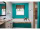 Bathroom featuring a bathtub with stone surround, plus a window and stylish fixtures at 222 Sinclair Rd, Summerville, SC 29483