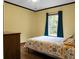 Cozy bedroom with a large window and warm hardwood floors and walls at 222 Sinclair Rd, Summerville, SC 29483