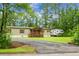Charming single-story home with a inviting front porch and lush greenery at 222 Sinclair Rd, Summerville, SC 29483