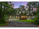 Charming single-story home with a front porch, a driveway, and surrounded by lush greenery and trees at 222 Sinclair Rd, Summerville, SC 29483